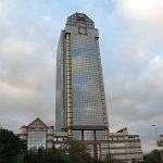 A large building with a clock on the top of it.