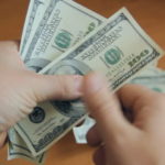 A person holding money in their hands