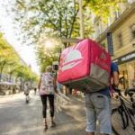 A man carrying a box on the street
