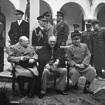 A group of men sitting on chairs in front of each other.